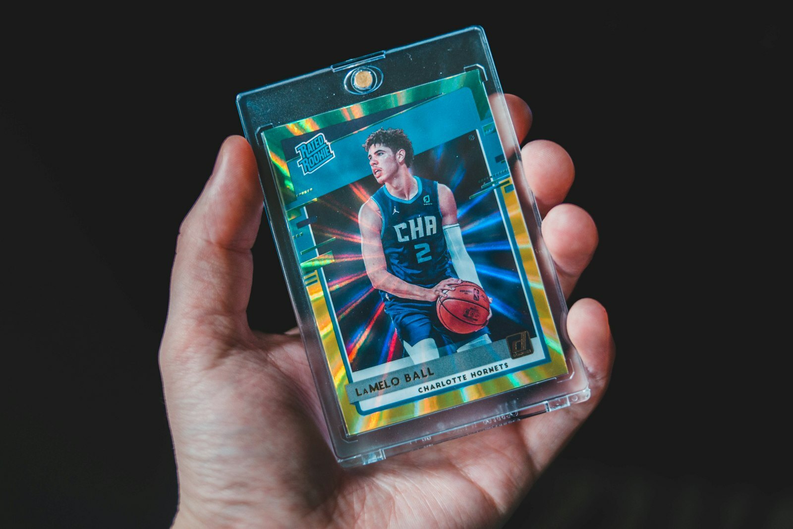 a person holding a basketball card in their hand